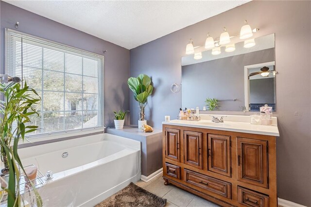 bathroom featuring tile patterned floors, vanity, and a tub