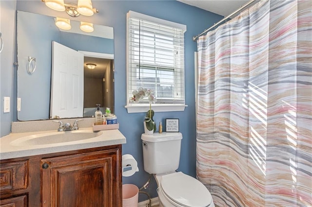 bathroom featuring vanity and toilet