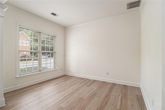 401 Wellwood Way, Roswell, GA 30075 - spare room featuring crown molding, light wood-style floors, and healthy amount of natural light