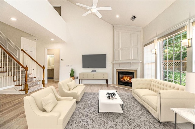 401 Wellwood Way, Roswell, GA 30075 - living room featuring light wood-style flooring, stairway, a ceiling fan, a large fireplace, and recessed lighting