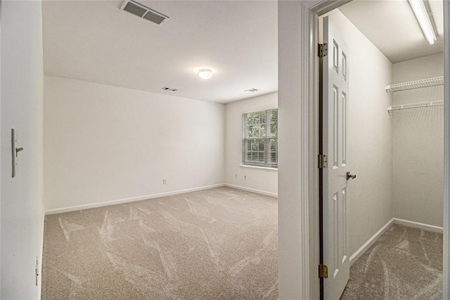 401 Wellwood Way, Roswell, GA 30075 - unfurnished bedroom featuring carpet flooring, a spacious closet, and a closet