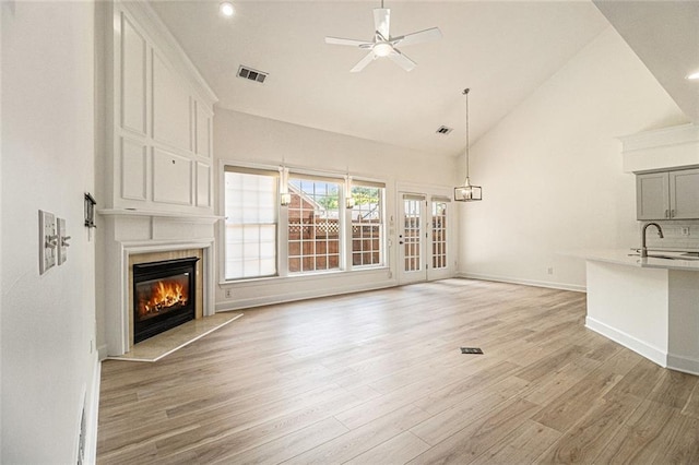 401 Wellwood Way, Roswell, GA 30075 - unfurnished living room featuring a large fireplace, light wood-style floors, ceiling fan, high vaulted ceiling, and recessed lighting