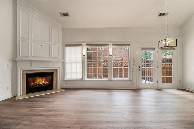 401 Wellwood Way, Roswell, GA 30075 - unfurnished living room featuring wood finished floors, a large fireplace, and a chandelier