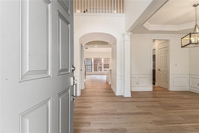 401 Wellwood Way, Roswell, GA 30075 - corridor featuring arched walkways, light wood-style flooring, a decorative wall, ornamental molding, and a wainscoted wall
