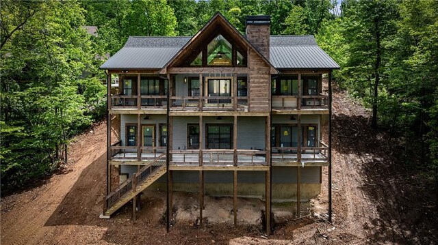 LOT40 Staurolite Mtn, Blue Ridge, GA 30513 - back of property with a balcony, a chimney, metal roof, stairs, and a wooded view