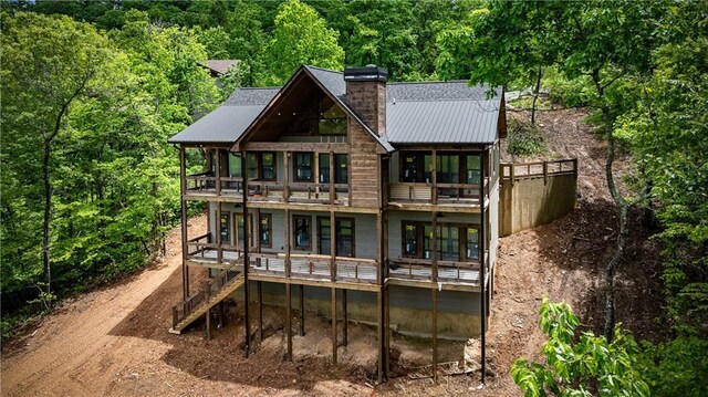 LOT40 Staurolite Mtn, Blue Ridge, GA 30513 - rear view of property with a balcony, a chimney, metal roof, and a view of trees
