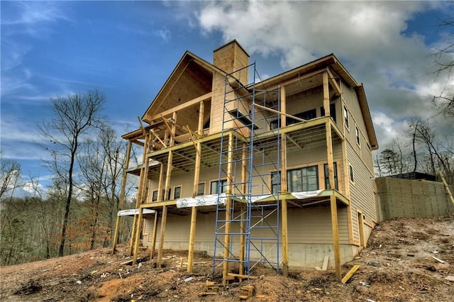 back of house featuring a balcony