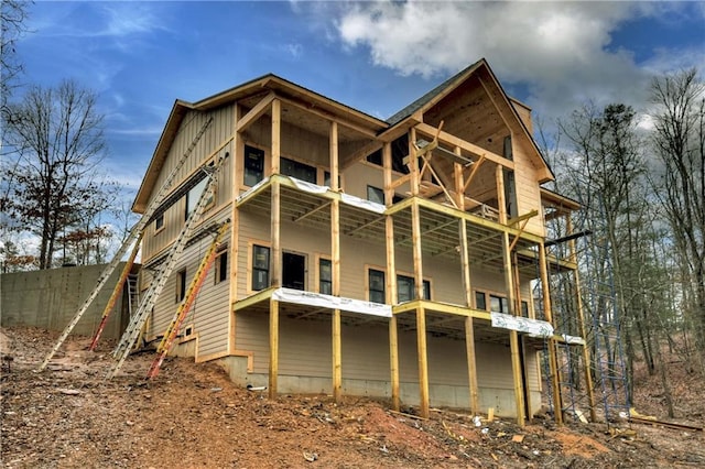 rear view of property with a balcony