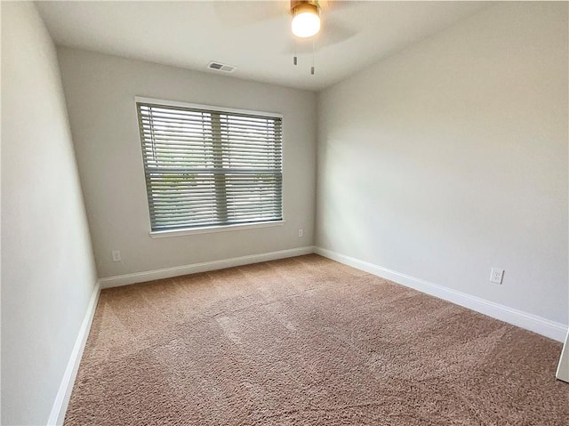 carpeted empty room featuring ceiling fan