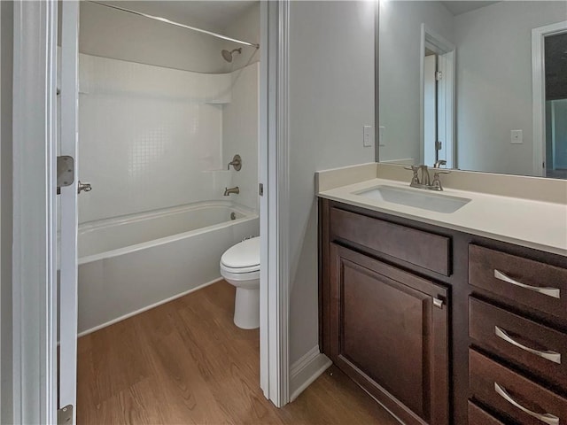 full bathroom featuring hardwood / wood-style floors, vanity,  shower combination, and toilet