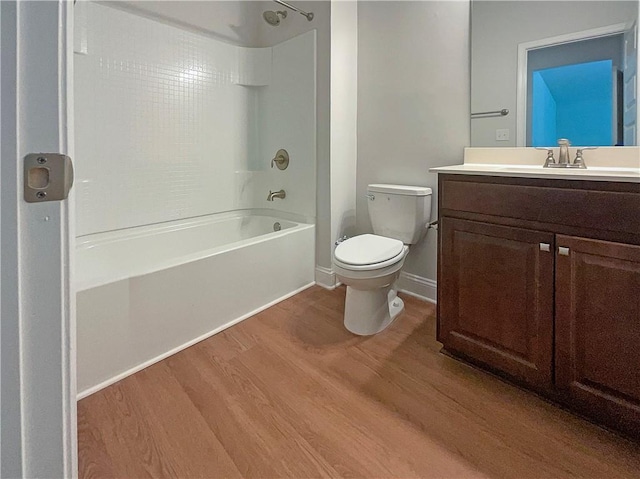 full bathroom with toilet, vanity, tub / shower combination, and hardwood / wood-style flooring