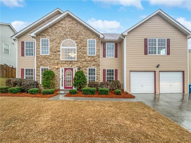 view of front of property featuring stone siding, concrete driveway, a garage, and a front yard