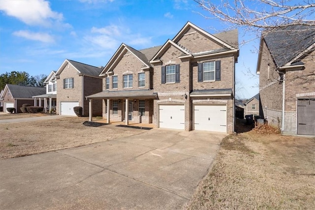 view of front of property with a garage, a porch, and a front yard