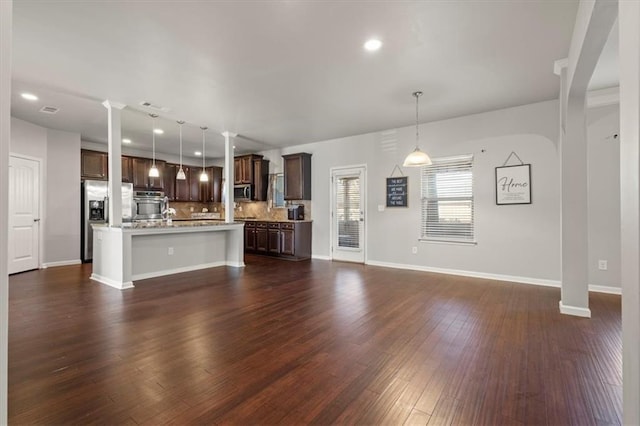 unfurnished living room with sink and dark hardwood / wood-style floors