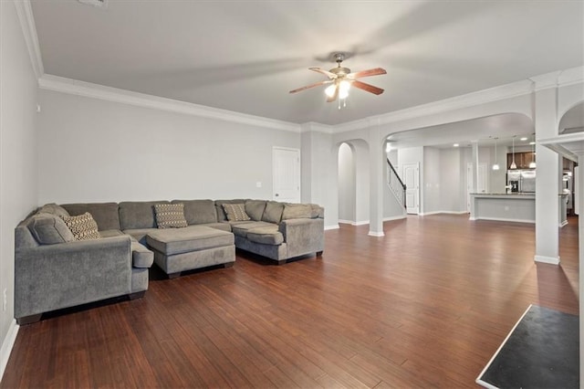 living room featuring ornamental molding, ceiling fan, and dark hardwood / wood-style flooring