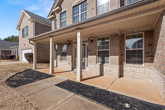 entrance to property with a garage and covered porch