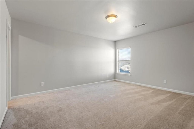 spare room with light carpet