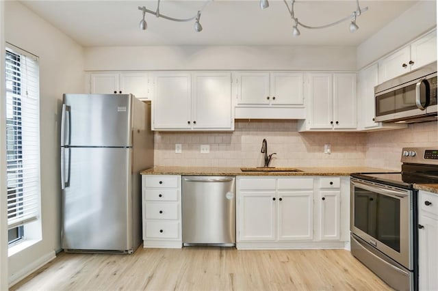 kitchen featuring white cabinets, light hardwood / wood-style floors, stainless steel appliances, and sink