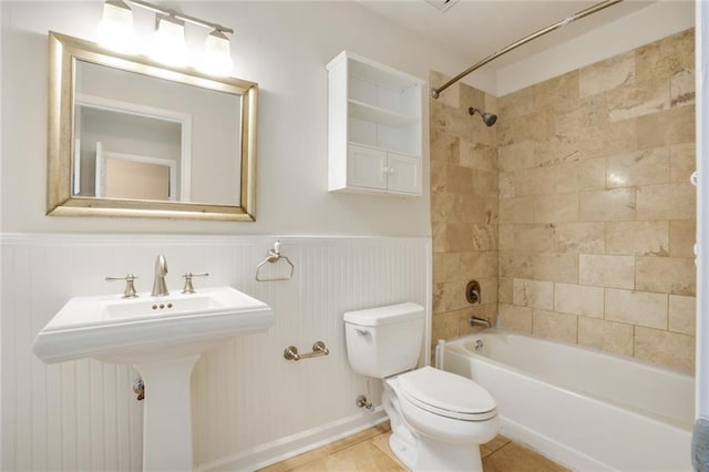 full bathroom featuring tile patterned flooring, toilet, sink, and tiled shower / bath