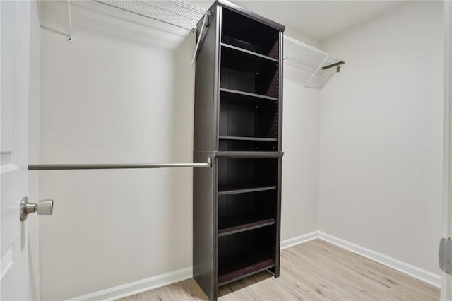 spacious closet featuring light hardwood / wood-style floors