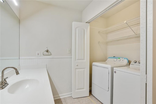 laundry area with washer and clothes dryer and sink