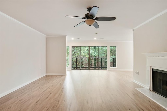 unfurnished living room featuring ceiling fan, ornamental molding, and light hardwood / wood-style floors