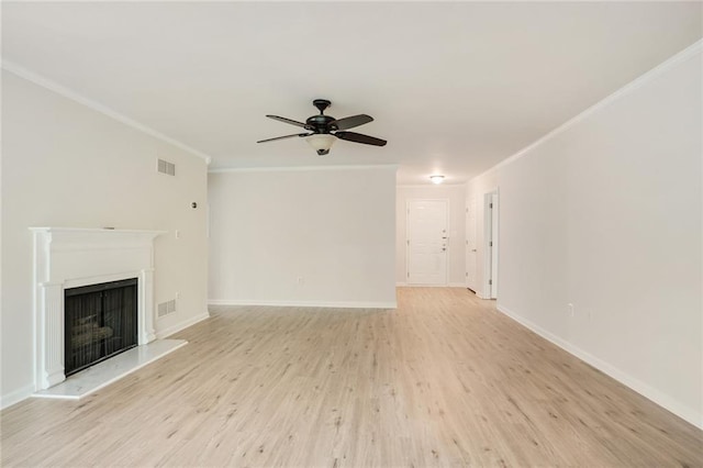 unfurnished living room with ceiling fan, ornamental molding, and light hardwood / wood-style floors