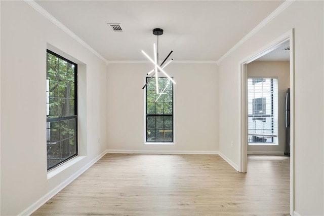 unfurnished dining area with light hardwood / wood-style flooring, plenty of natural light, and crown molding