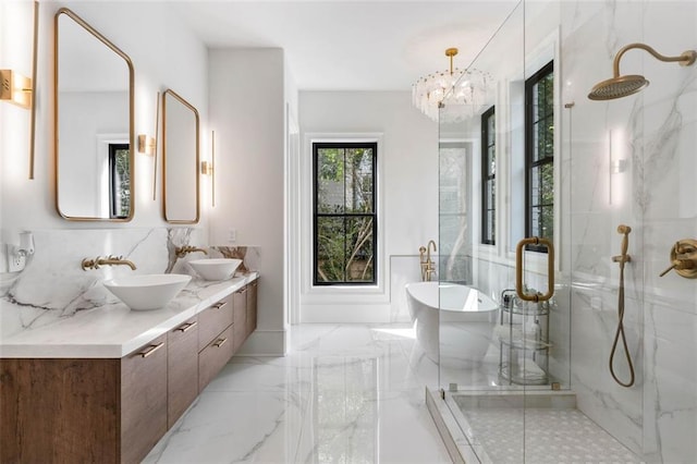 bathroom featuring vanity, separate shower and tub, and a chandelier