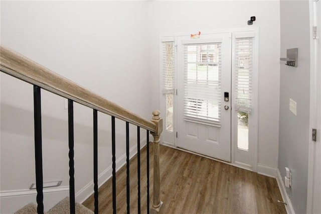 entrance foyer featuring wood finished floors, baseboards, and stairway