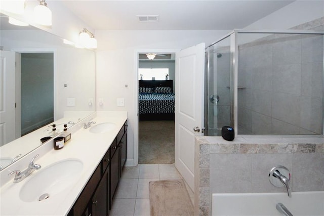 full bathroom featuring a shower stall, tile patterned floors, ensuite bath, double vanity, and a bathtub