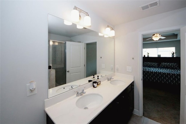 bathroom with tile patterned floors, double vanity, and ceiling fan