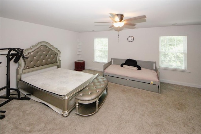 bedroom with carpet floors, baseboards, and a ceiling fan