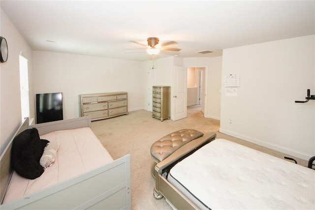 bedroom featuring ceiling fan, light colored carpet, and baseboards