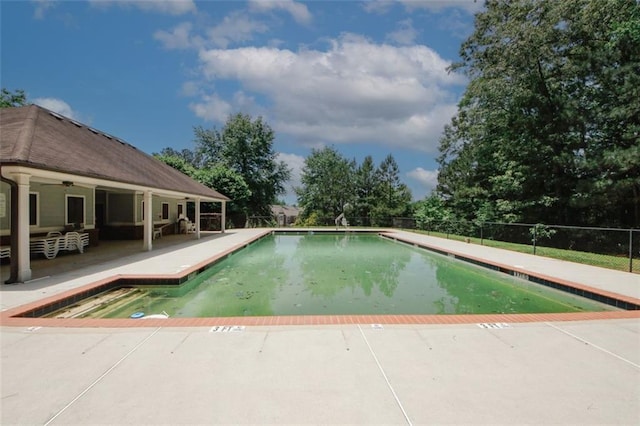 community pool featuring a patio and fence