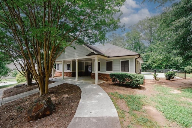view of front of property with fence and brick siding
