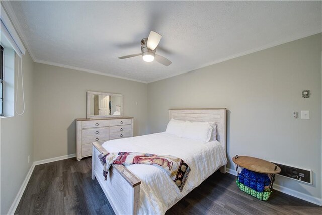 bedroom with a textured ceiling, dark hardwood / wood-style flooring, ceiling fan, and ornamental molding