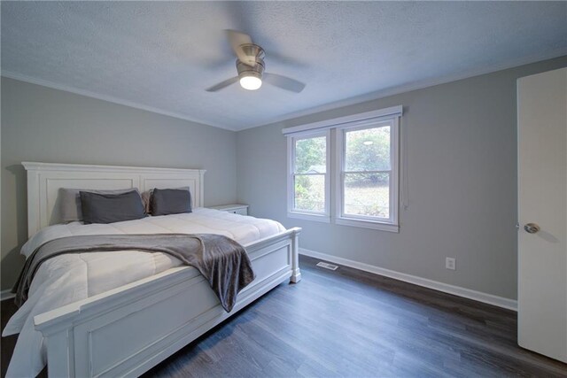 bedroom featuring ceiling fan, dark hardwood / wood-style flooring, and crown molding