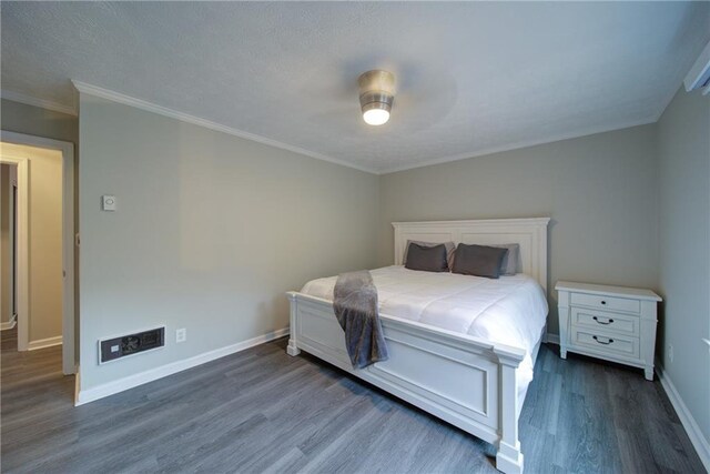 bedroom with a textured ceiling, ceiling fan, and dark wood-type flooring