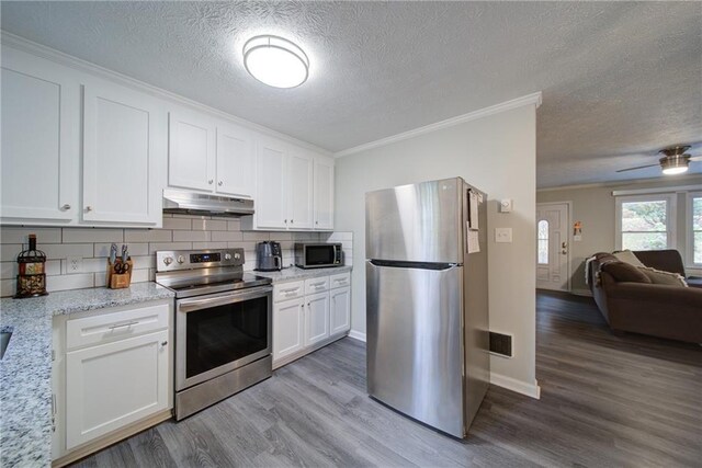 kitchen with appliances with stainless steel finishes, crown molding, sink, light hardwood / wood-style flooring, and white cabinets