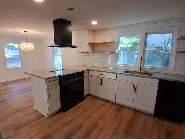 816 Stewart St, Carrollton, GA 30117 - kitchen with range hood, a sink, open shelves, black appliances, and a peninsula