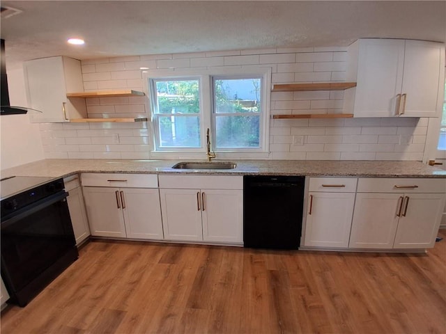 816 Stewart St, Carrollton, GA 30117 - kitchen with black appliances, light stone counters, open shelves, and a sink