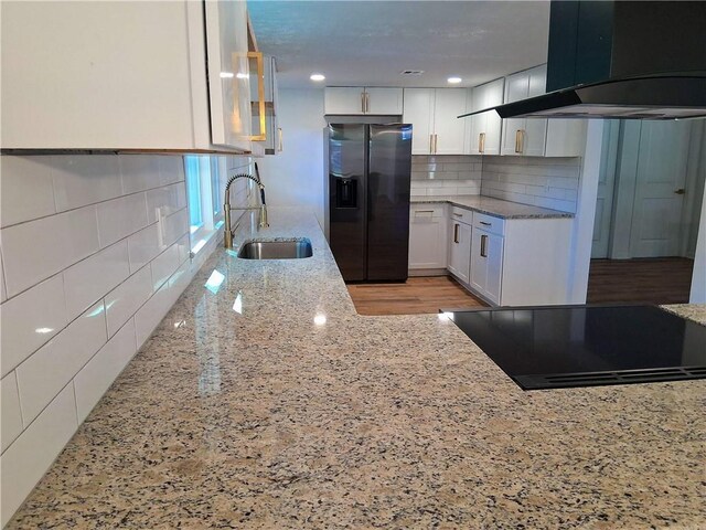 816 Stewart St, Carrollton, GA 30117 - kitchen featuring white cabinetry, a sink, black appliances, light stone countertops, and exhaust hood