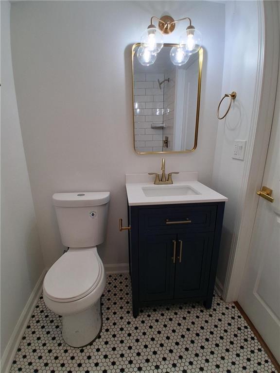 816 Stewart St, Carrollton, GA 30117 - bathroom with toilet, vanity, tile patterned flooring, and baseboards