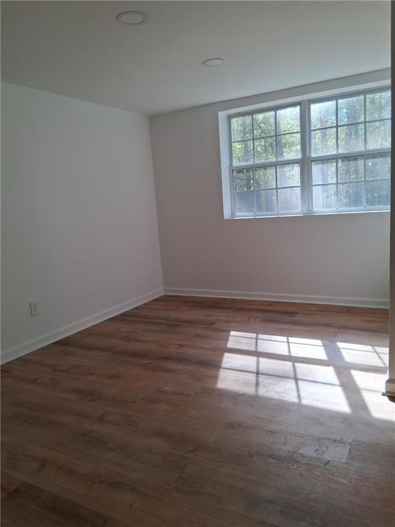 816 Stewart St, Carrollton, GA 30117 - unfurnished room with baseboards and wood finished floors