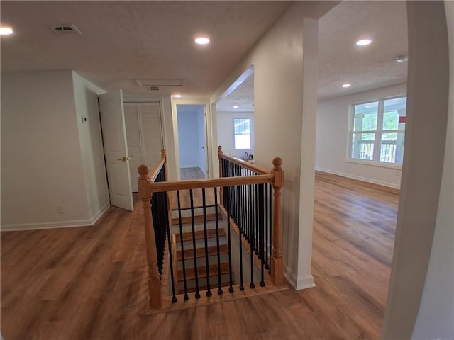 816 Stewart St, Carrollton, GA 30117 - hall featuring an upstairs landing, visible vents, and wood finished floors