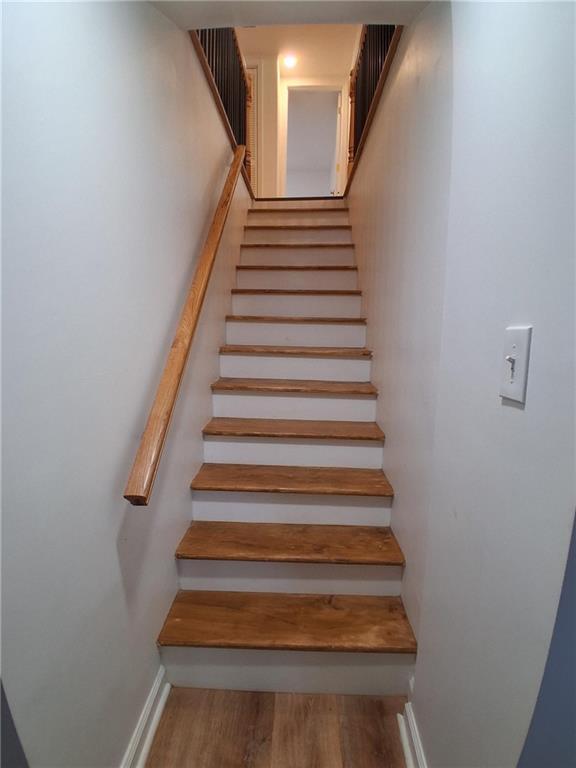 816 Stewart St, Carrollton, GA 30117 - stairway featuring wood finished floors and baseboards