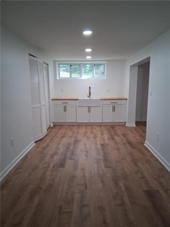 816 Stewart St, Carrollton, GA 30117 - kitchen with white cabinets, a sink, baseboards, recessed lighting, and wood finished floors