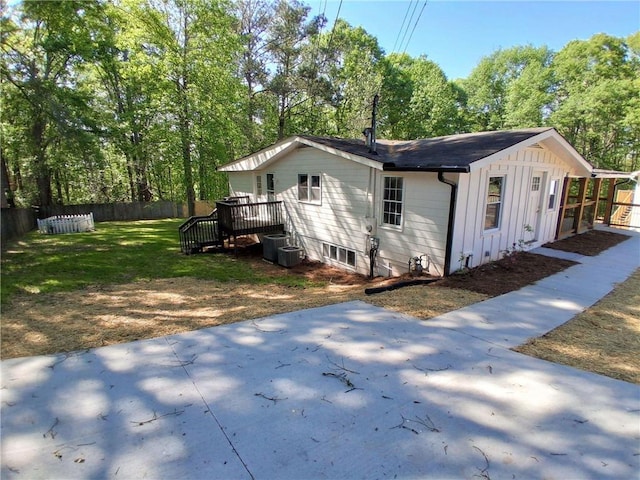 816 Stewart St, Carrollton, GA 30117 - view of side of property with cooling unit, board and batten siding, a patio, fence, and a yard