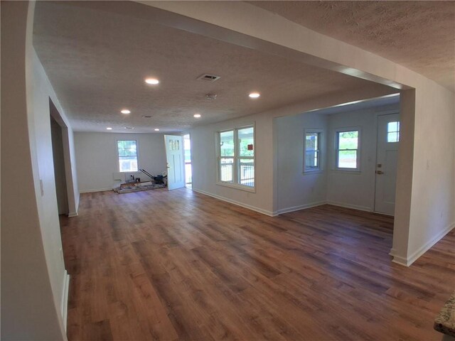 816 Stewart St, Carrollton, GA 30117 - unfurnished living room featuring recessed lighting, a textured ceiling, wood finished floors, and baseboards
